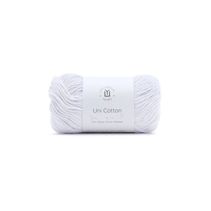 A single skein of white cotton yarn with a white paper label band in the center, photographed on a seamless white background.