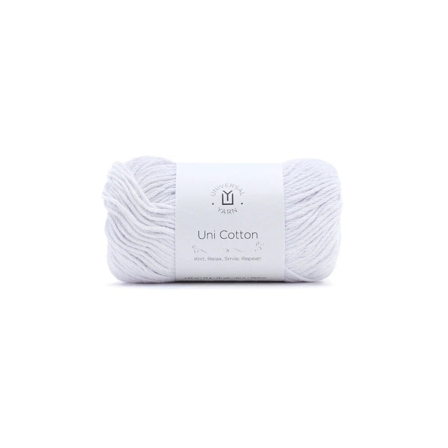A single skein of white cotton yarn with a white paper label band in the center, photographed on a seamless white background.