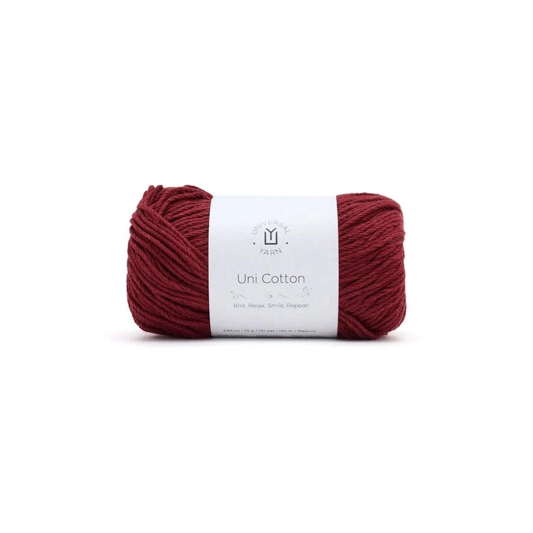 Red skein of yarn with a white label on a white background