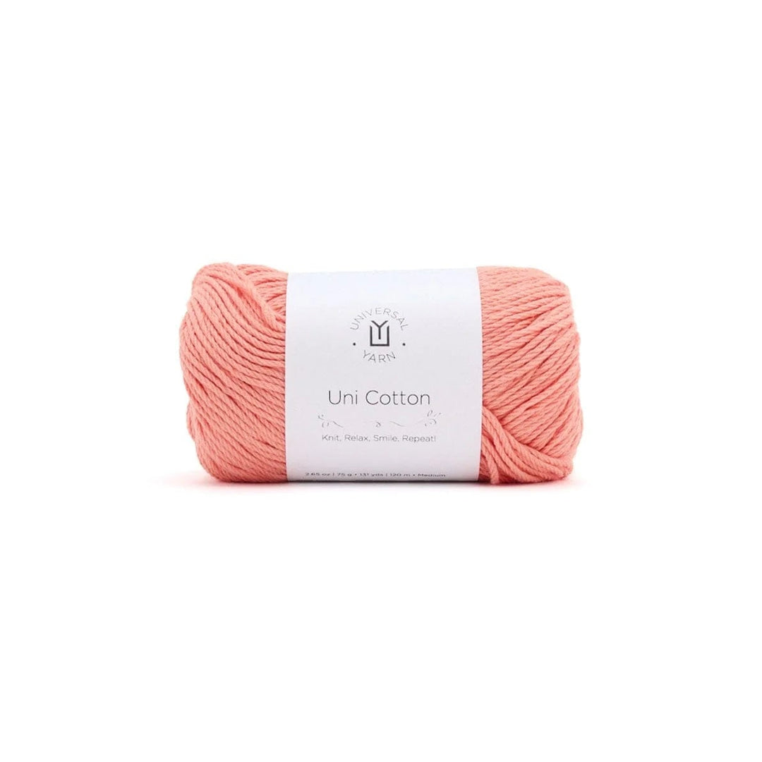 Ball of pink yarn with a label on a white background