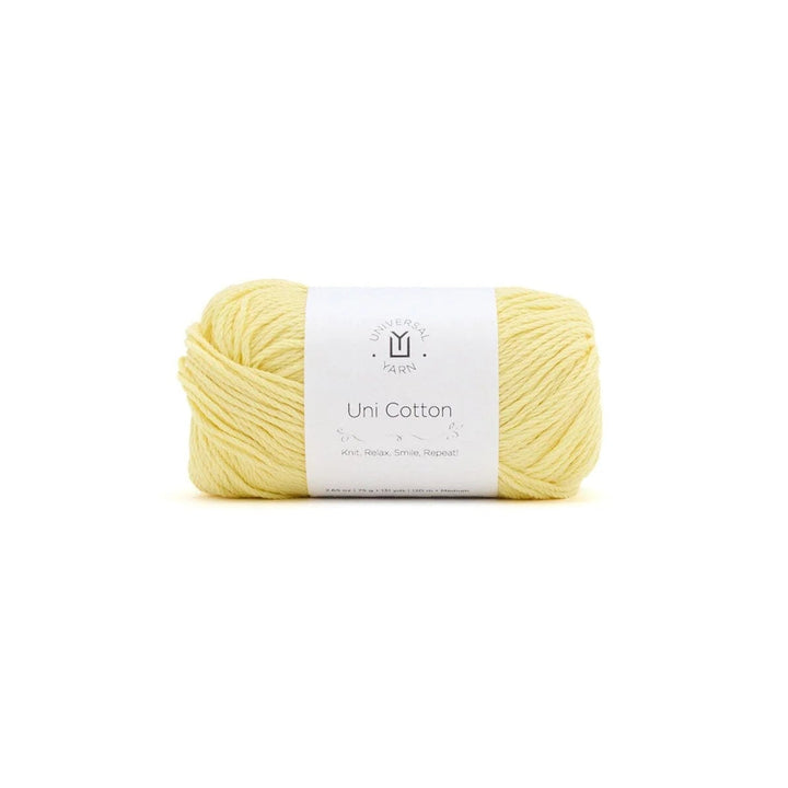 A single skein of pale yellow yarn with a white paper label, centered on a plain white background.