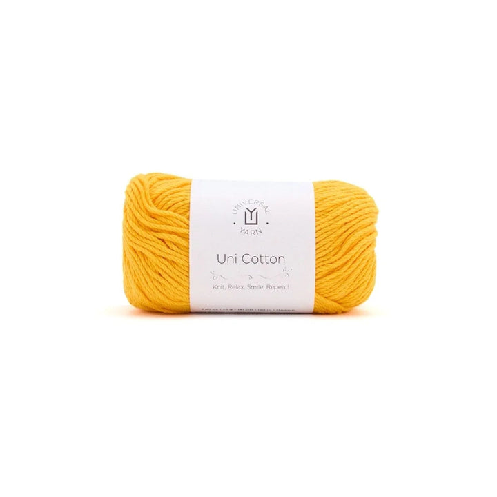 A skein of bright yellow yarn with a white paper label in the center, photographed on a seamless white background.