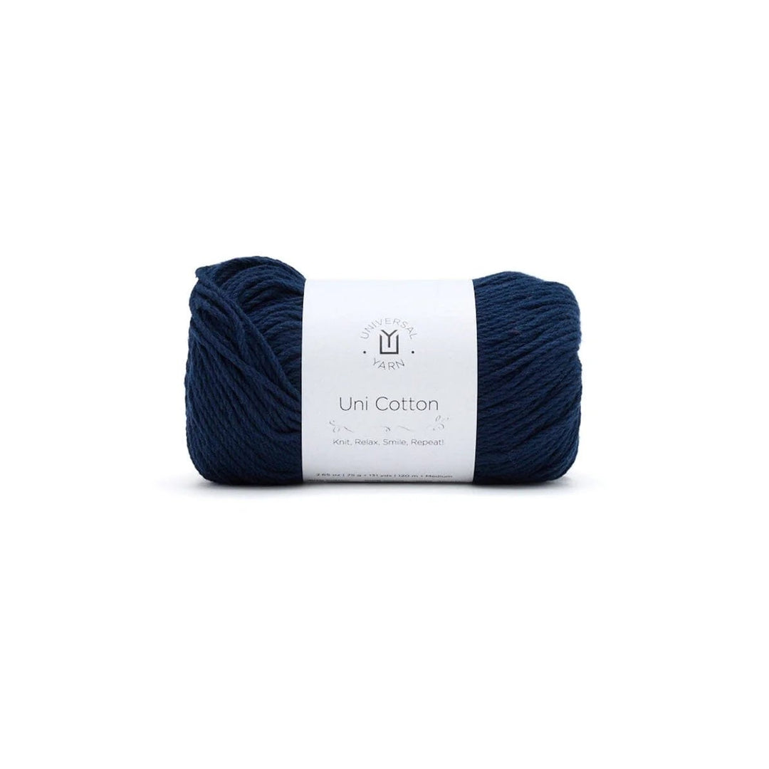 Navy blue yarn ball with a white label on a white background