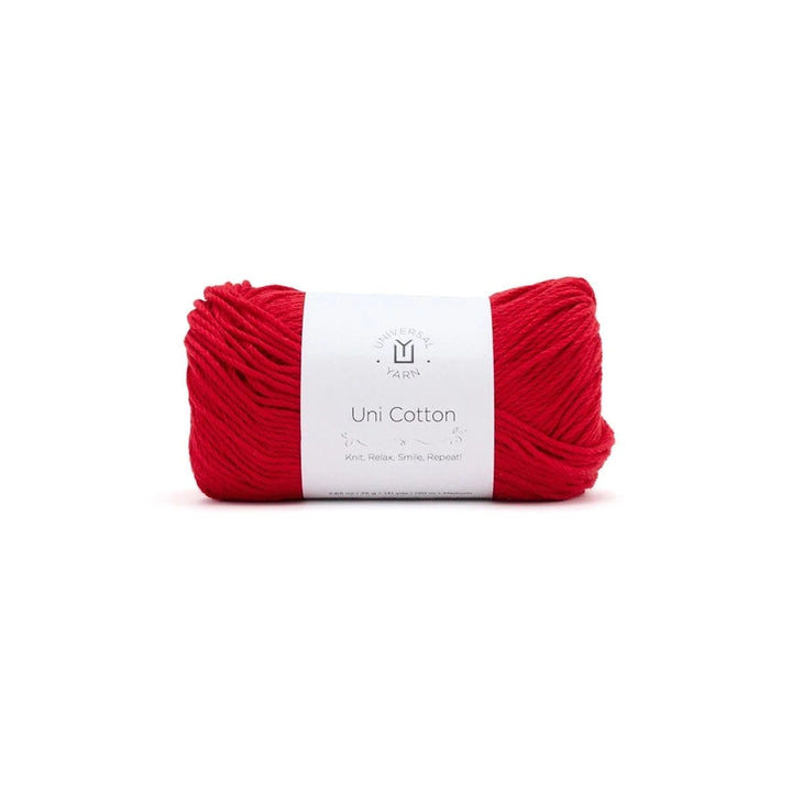 Red yarn ball with a white label on a white background