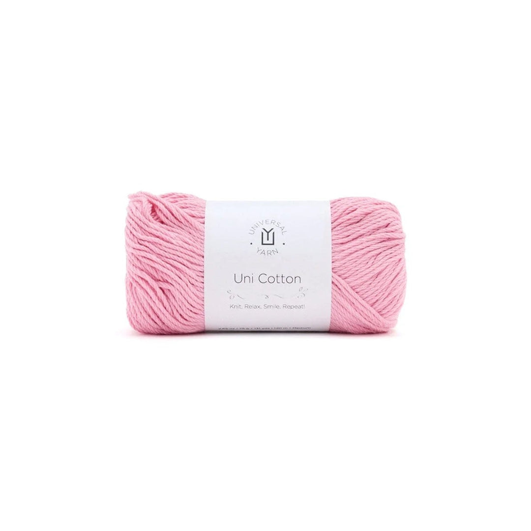 A skein of light pink yarn with a white paper label wrapped around it, centered on a plain white background.