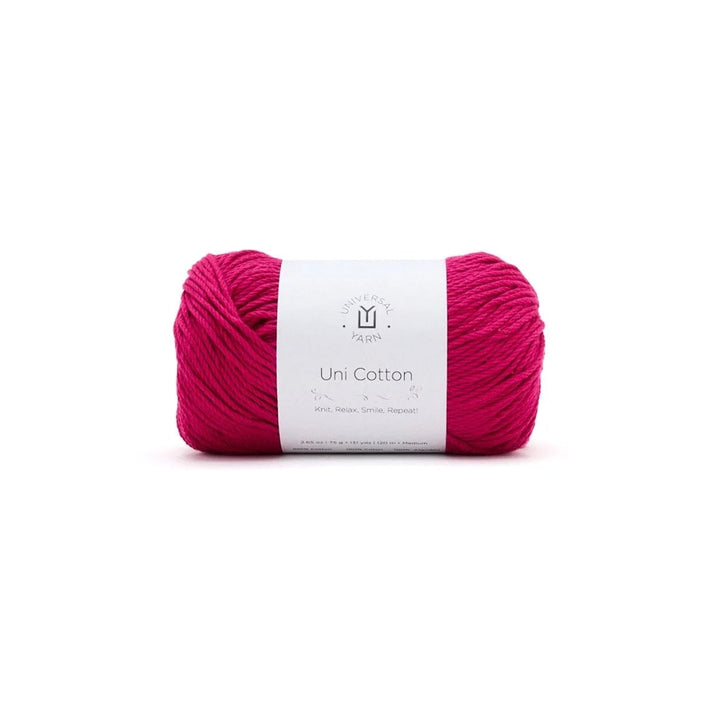 Pink yarn ball with a white label on a white background