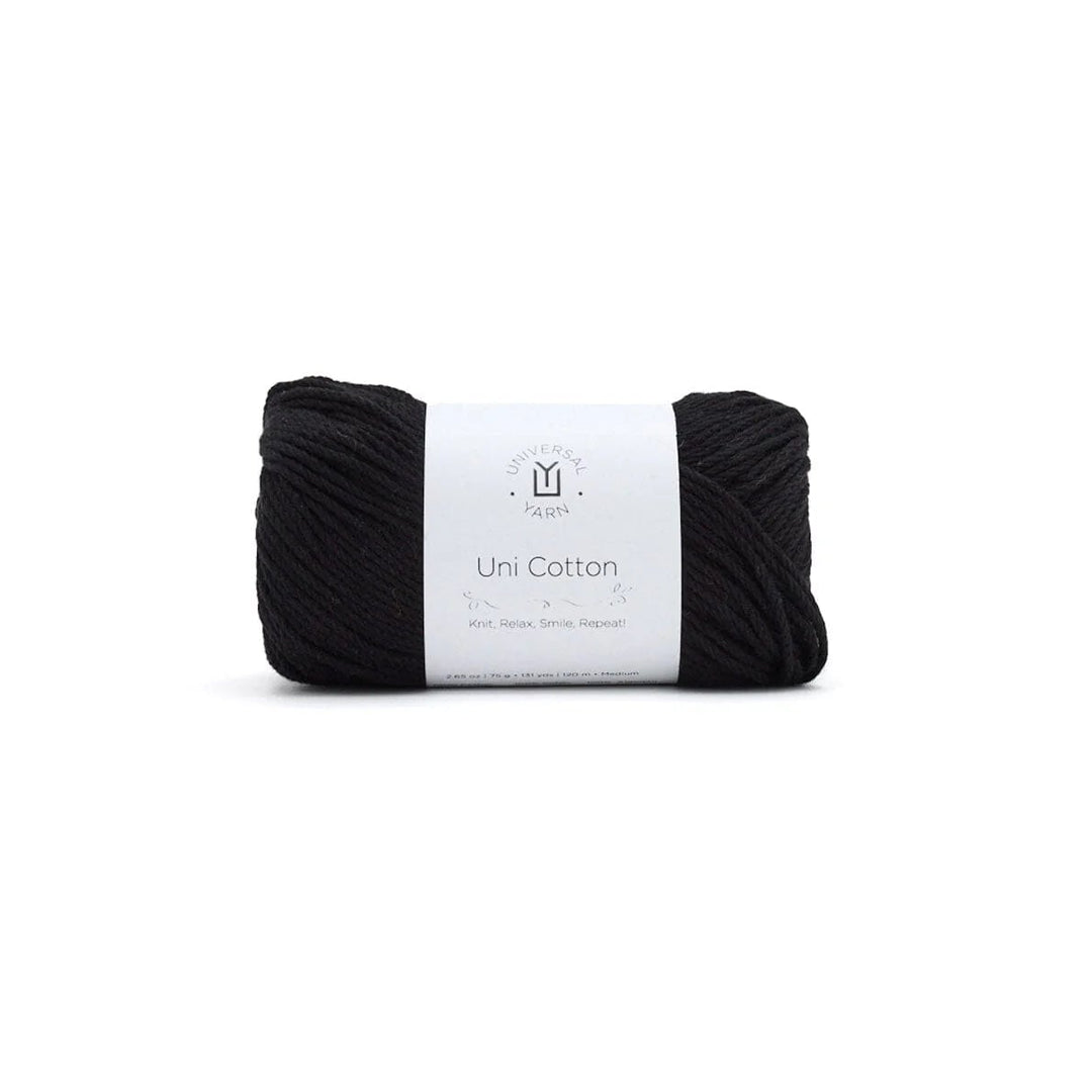Black yarn ball with a white label on a white background