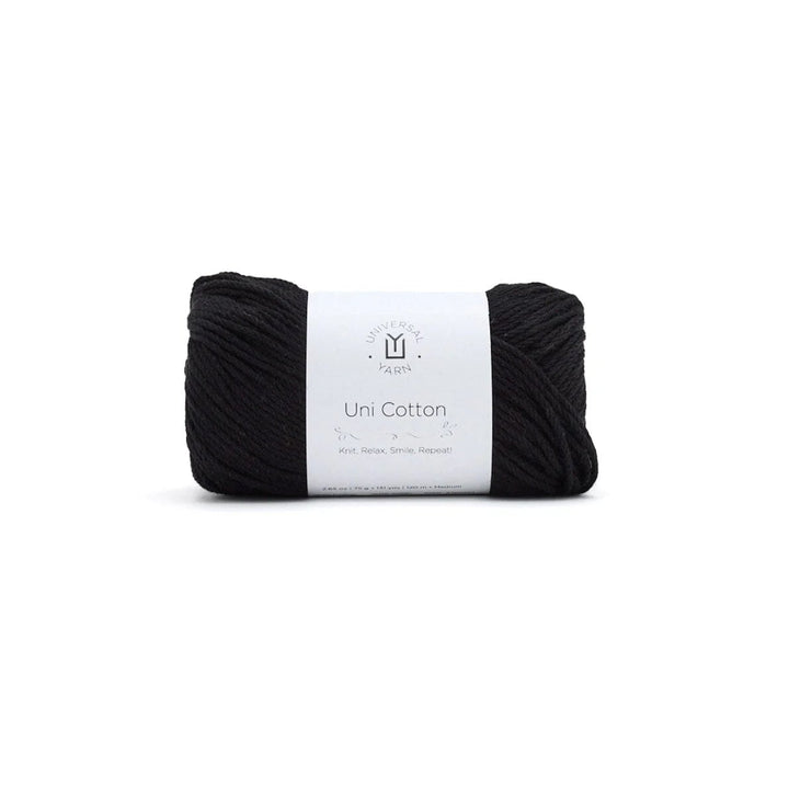 Black yarn ball with a white label on a white background