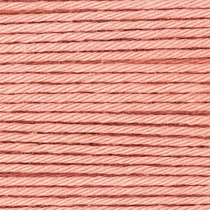 Close-up of pink thread with a textured surface